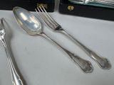 three forks and two spoons sitting on a table