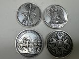 three silver coins with a picture of an eagle and a knight on them