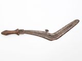 an old knife with a wooden handle sitting on top of a white surface