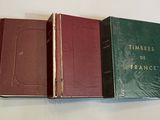 three books sitting on top of a table next to each other