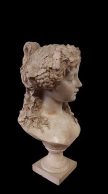 marble bust of a woman with curly hair on a black background
