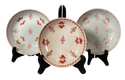 three plates that are sitting on a stand