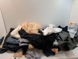 a pile of clothes sitting on a counter in front of a mirror