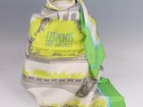yellow and white scarf with green trim on a gray background