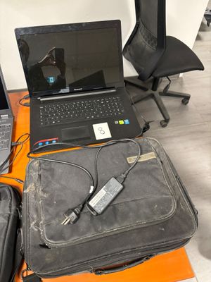 un ordinateur portable posé sur une valise