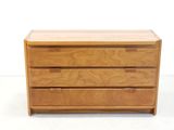 an image of a wooden chest of drawers on a white surface