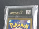 a pokemon card in a plastic case on a table