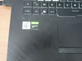 a close up of a laptop on a table with a cable