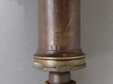 a close up of a metal pipe on a white wall