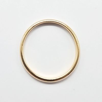 a close up of a gold ring on a white surface
