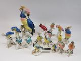 many figurines of birds that are sitting on a table