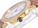 an image of a close up of a wrist watch with a blue stone