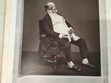 an old black and white photo of a man sitting in a chair