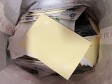 a bag full of mail and a piece of paper in it