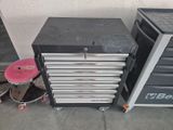 a black and silver tool cabinet and a pink stool