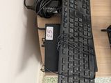 a computer keyboard and mouse on a desk with a mouse pad