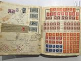 an open book with stamps and stamps on it sitting on a table