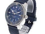 a close up of a watch on a white background with a blue dial