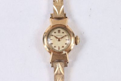 a gold wrist watch with a white face on a white surface