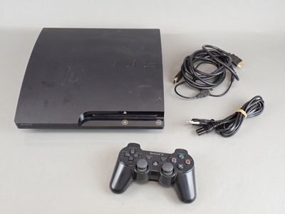 a video game console with a game controller next to it