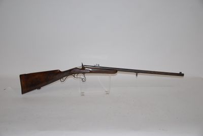 a rifle on a white surface with a white background