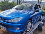 a blue car on a trailer being towed by a truck