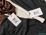 two jackets with tags attached to them sitting on top of a table