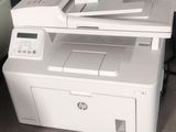 a printer sitting on top of a desk next to a chair