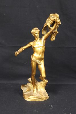 bronze statue of a woman holding a bird in her hand