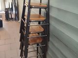 a ladder that is leaning against a wall next to a chair