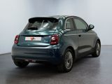the rear end of a small blue car parked in a room