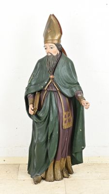 figurine of a man dressed in a green robe and a hat