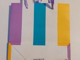 a paper bag with a purple handle and a barcode on it