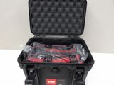 an open black case with tools in it sitting on a white surface