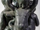 a statue of two children holding a bowl on top of it