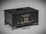 a small black box with a key on top of it