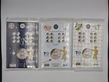 four different types of silver coins in plastic bags on a white surface
