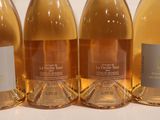four bottles of wine are lined up on a table