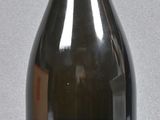 a black bottle with a yellow lid on a gray surface