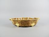 a yellow bowl sitting on top of a table next to a white wall