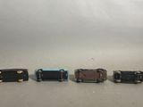 four miniature trains that are lined up on a table
