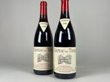 two bottles of red wine sitting next to each other on a table