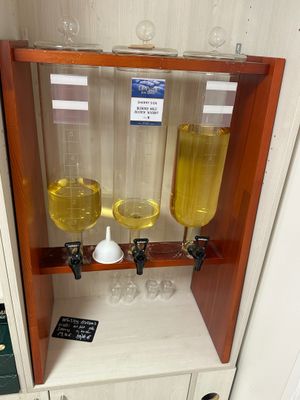 trois verres remplis d'un liquide jaune posés sur une étagère dans une pièce