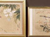 two framed asian paintings of birds and flowers in a gold frame