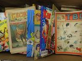 a box full of comics and books on the shelf