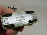 a person holding a silver and black toy car