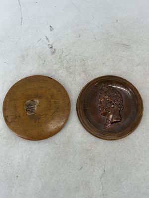 two wooden buttons that are sitting next to each other