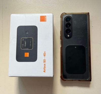 a box with a phone inside of it on a table