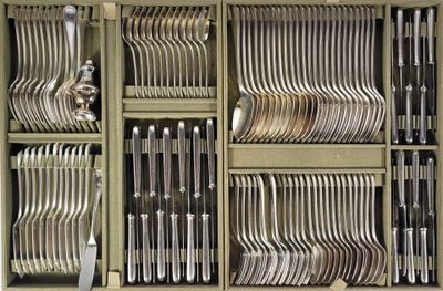 a lot of forks and spoons in a cabinet