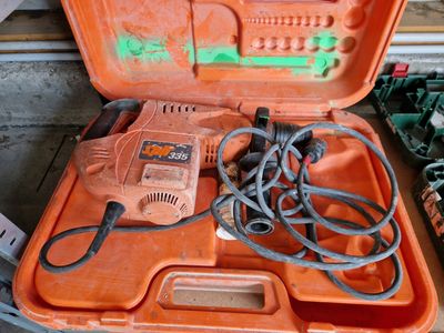 an orange tool case with tools in it on a table